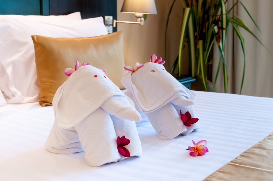 Elephant origami towel on the bed of a hotel.