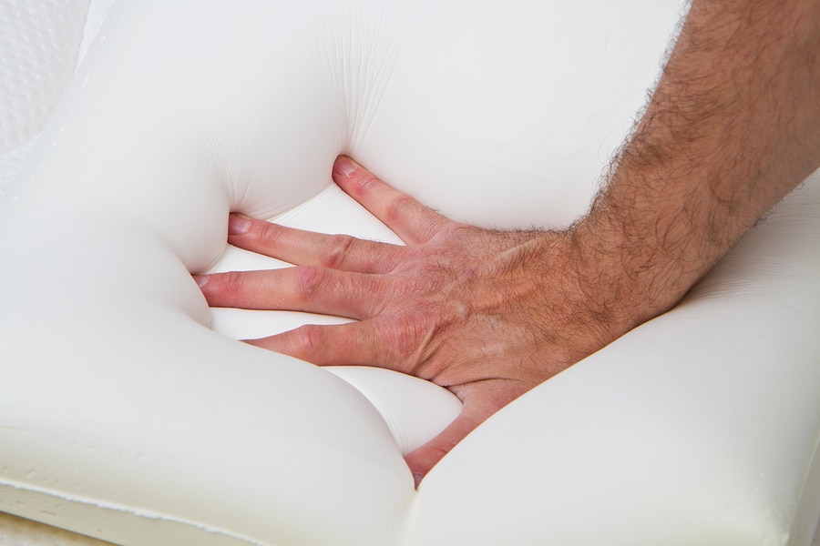 man' hand demonstrating thick luxury memory foam mattress topper