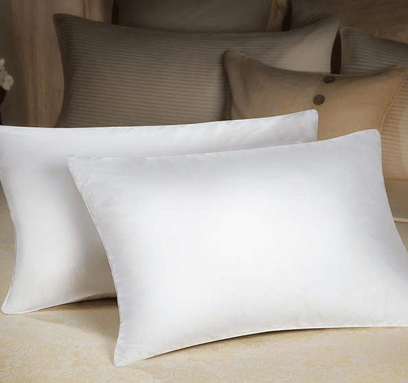 Two luxury dolce vita eco pillows by Sobel at Home on hotel bed