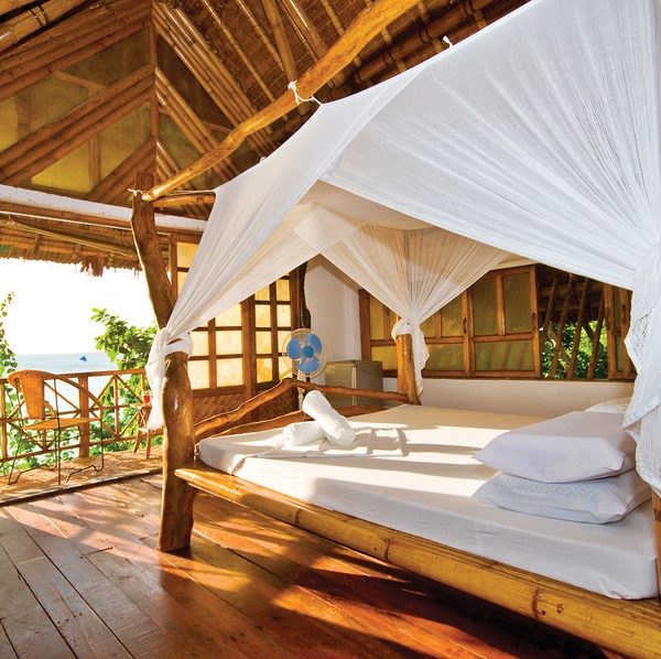 eco lodge bedroom with bamboo furniture and natural organic linens