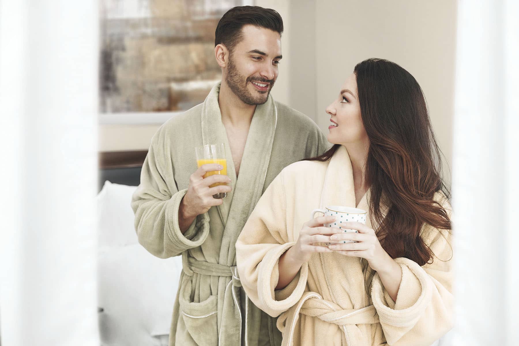 Models in urbana robes at home enjoying coffee and juice