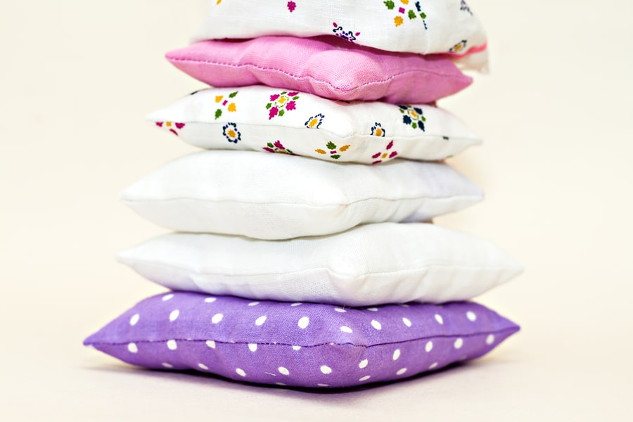 Tower of multi-colored bed pillows.