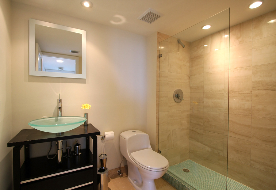 beautiful guest bathroom with designer pink toilet and glass washbasin