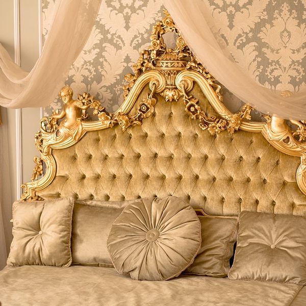 Royal bedroom interior. Interior of classic style bedroom in luxury villa. Beautiful royal and classical living room interior with a large bed in expensive apartment.