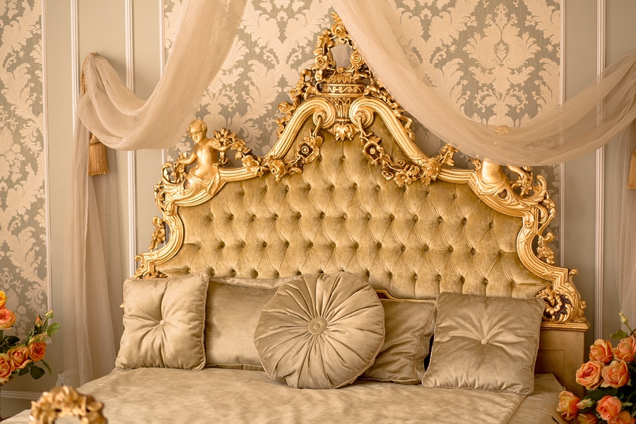 interior of classic style bedroom in luxury villa. Beautiful royal and classical style gold bed with luxury pillows