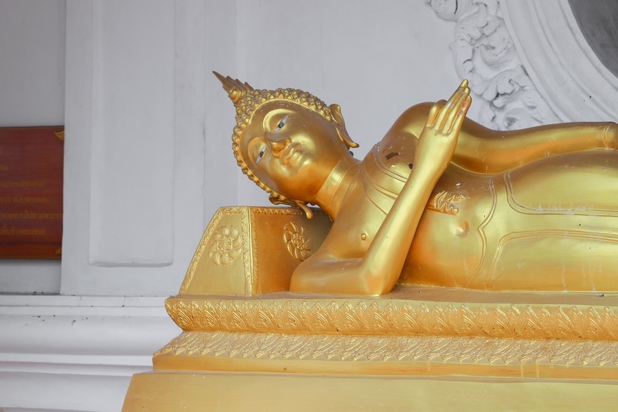 buddha statue sleeping on stone pillow in ancient in the Thai temple