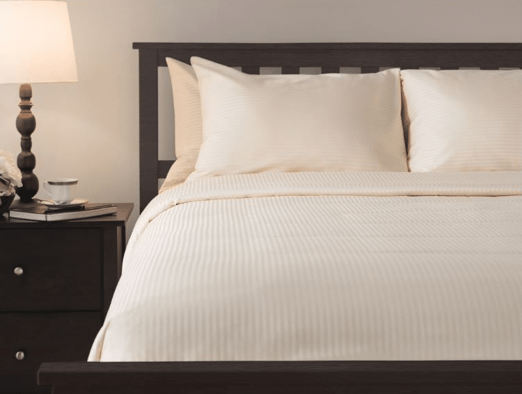 ni nights bed sheets executive style beige bedding on hotel bed