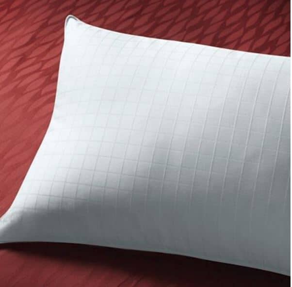 Sobella hotel bed pillow for side sleepers on a maroon bedspread