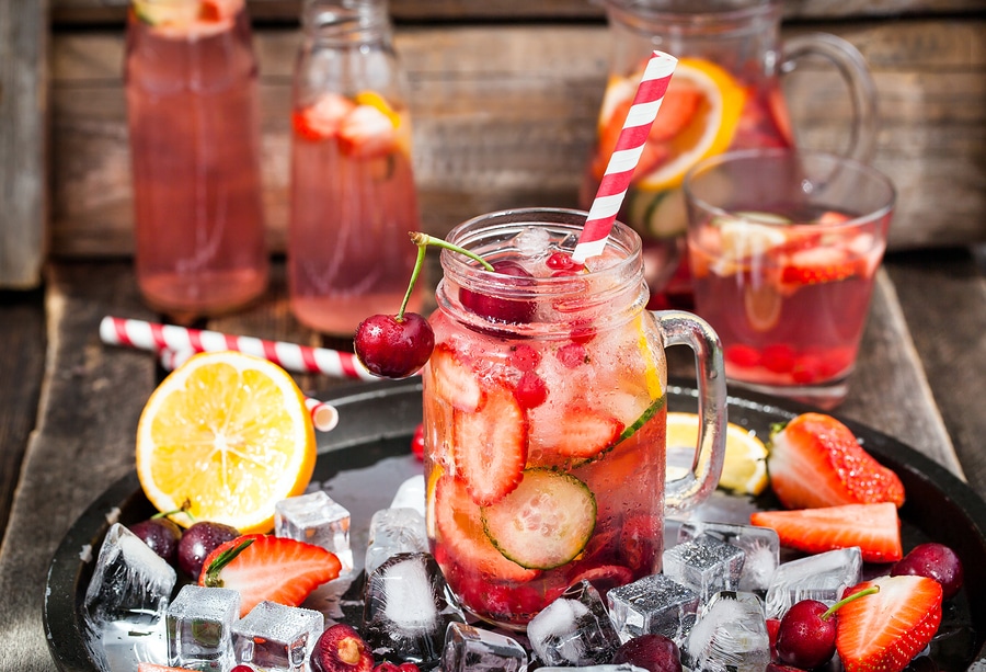 Healthy infused detox water with fresh berries and fruits in mason jar