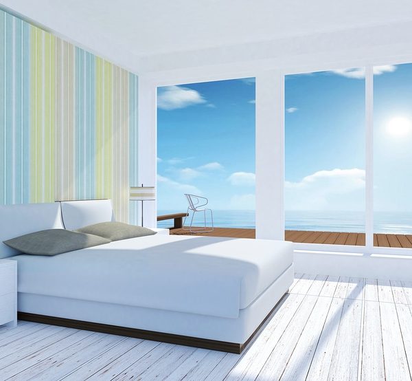 White and pastel modern bedroom interior with sea view in summer