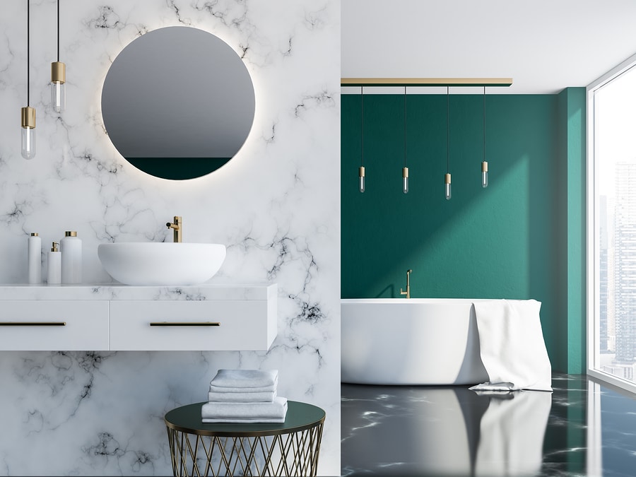 White marble and dark green loft bathroom with a sink, a round mirror and a tub near a loft window