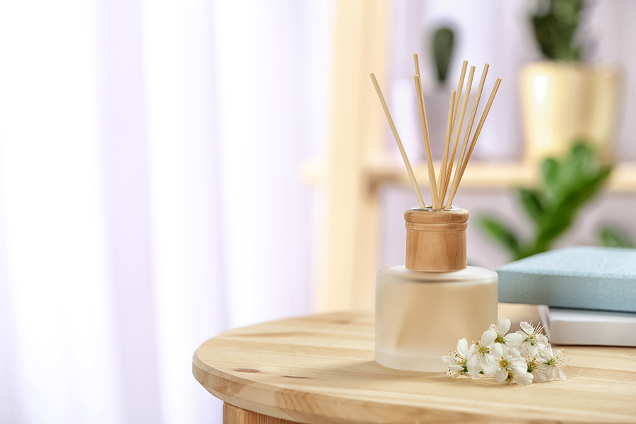 Aromatic reed freshener on table in room