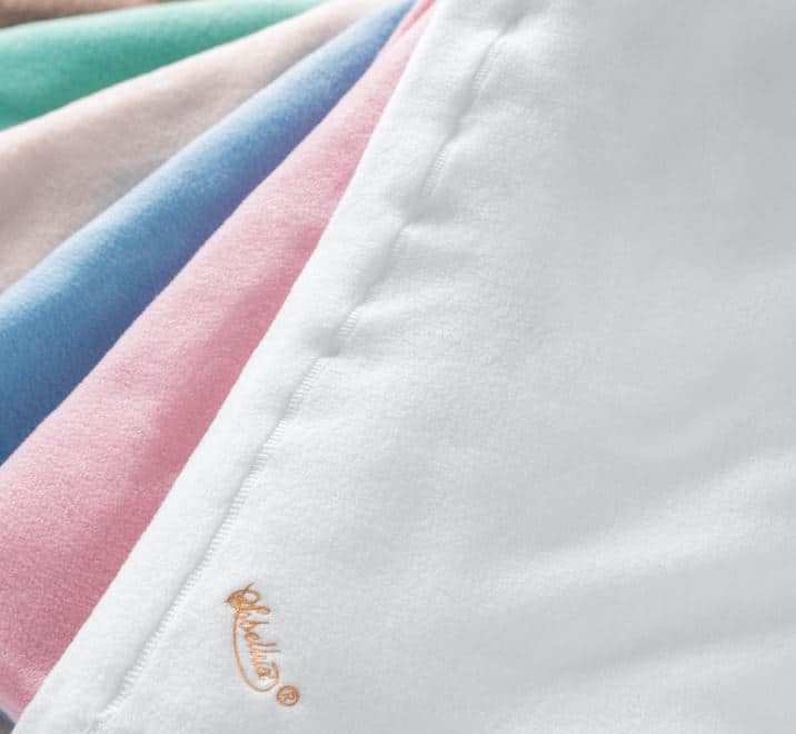 Sobel Westex fleece blankets laid out to show 5 pastel colors