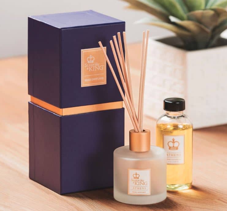 Sobel Westex reed diffuser on table next to purple gift box and jar of Athens scented oil