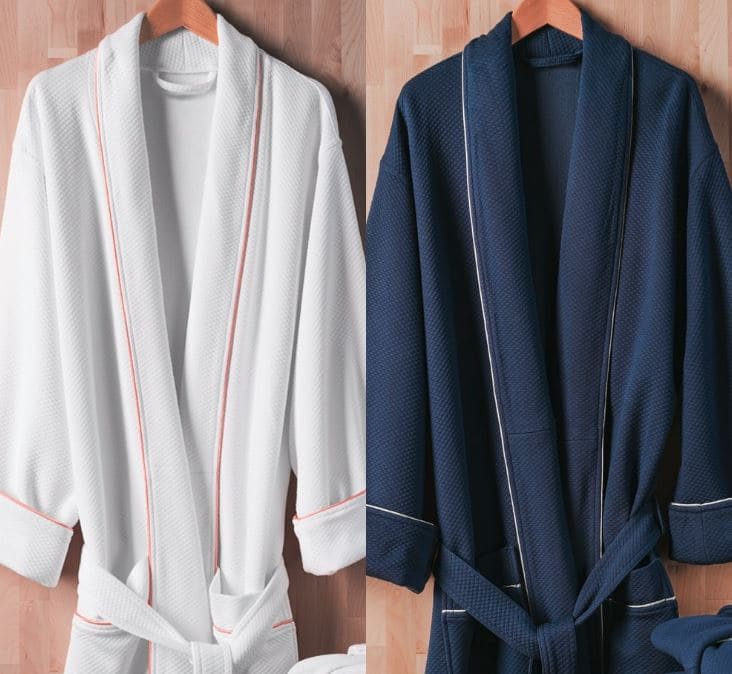 Two Sobel diamond spa robes side by side white with gold trim and blue with white trim