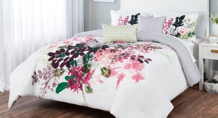 Sobel floral comforter set white with Euro style flower print displayed on a bed in a bright bedroom