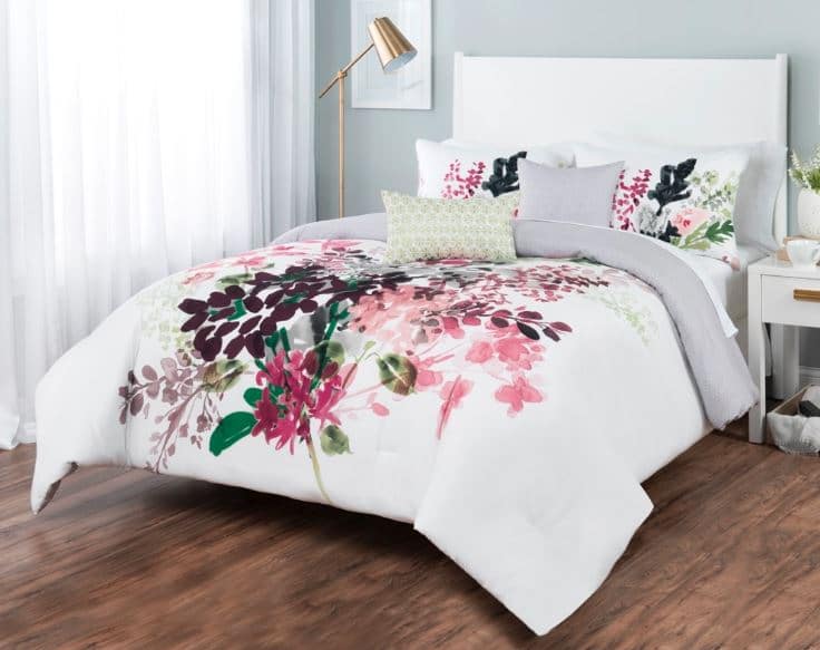 Sobel floral comforter set white with Euro-style flower print displayed on a bed in a bright bedroom