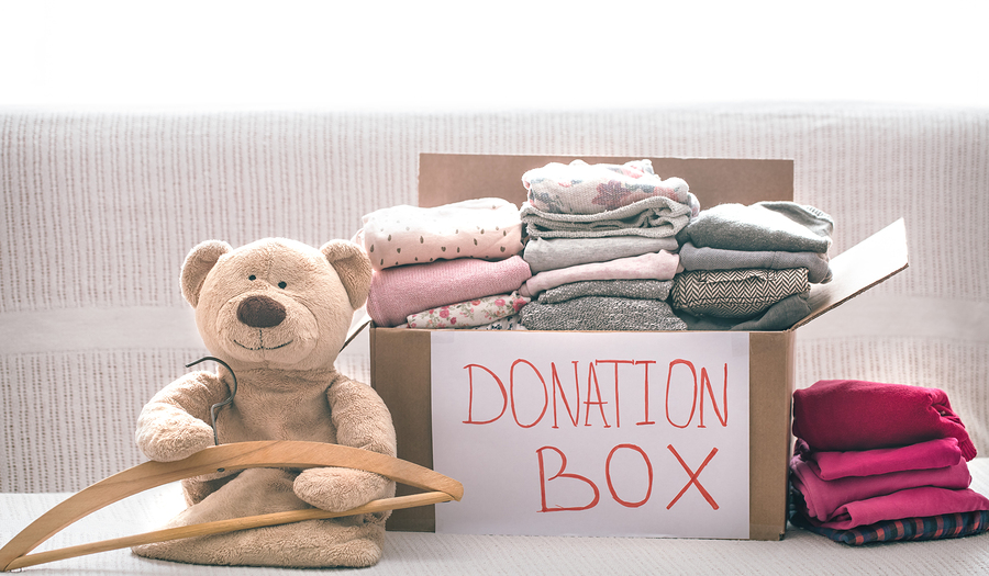 Donations box with clothes and used bedding for charity