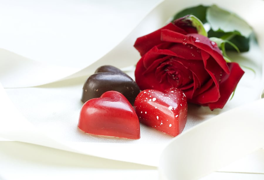 Valentine's Day card and chocolate hearts and red rose