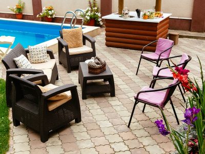 Summer pool patio furniture strawback chairs, bar and pick guest chairs in garden setting