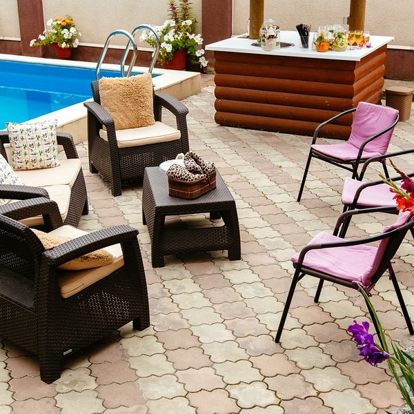 Summer pool patio furniture strawback chairs, bar and pick guest chairs in garden setting