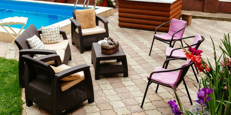 Summer pool patio furniture strawback chairs, bar and pick guest chairs in garden setting