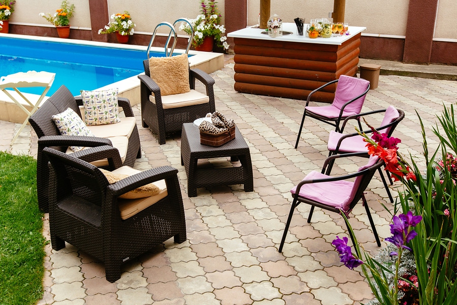 Summer pool patio furniture strawback chairs, bar and pick guest chairs in garden setting