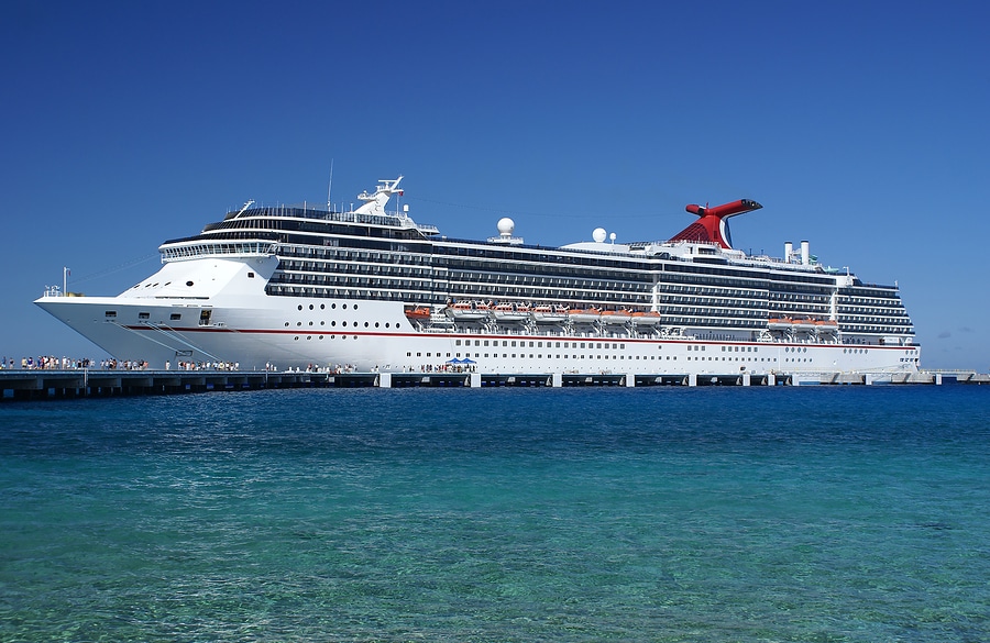 Luxury cruise liner at docks with passengers embarking and disembarking