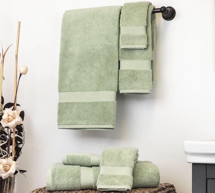 Sobel Westex Pyramid excel Egyptian cotton luxury hotel towels sage green hanging on bathroom towel rack and over wicker basket