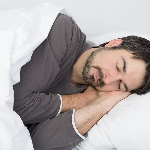 man with beard sleeping on his side on a comfortable pillow for a side sleeper