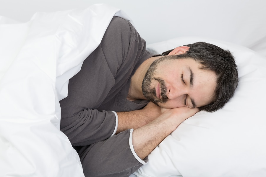 man with beard sleeping on his side on a comfortable pillow for a side sleeper 