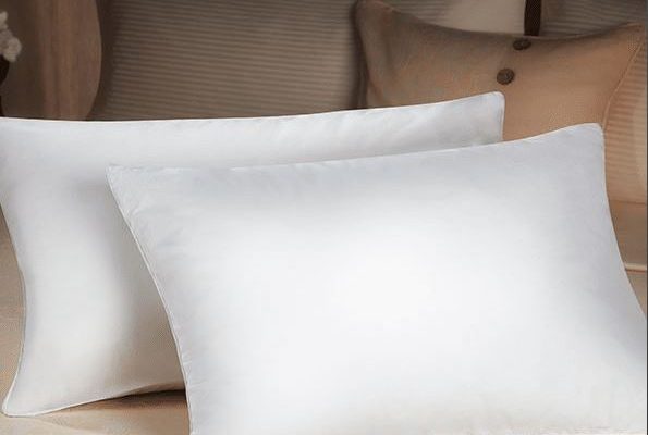 two sobel dolce vita eco pillows on bed thick and lofty