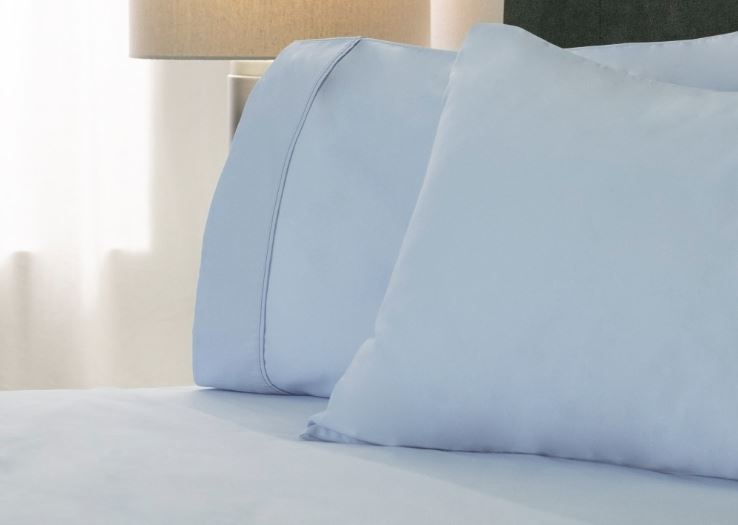 sobel westex sateen sheets and pillows blue on hotel bed showing two plush pillows