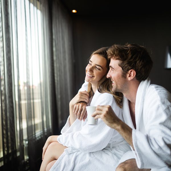 Couple wearing luxury spa robes enjoying wellness weekend and spa