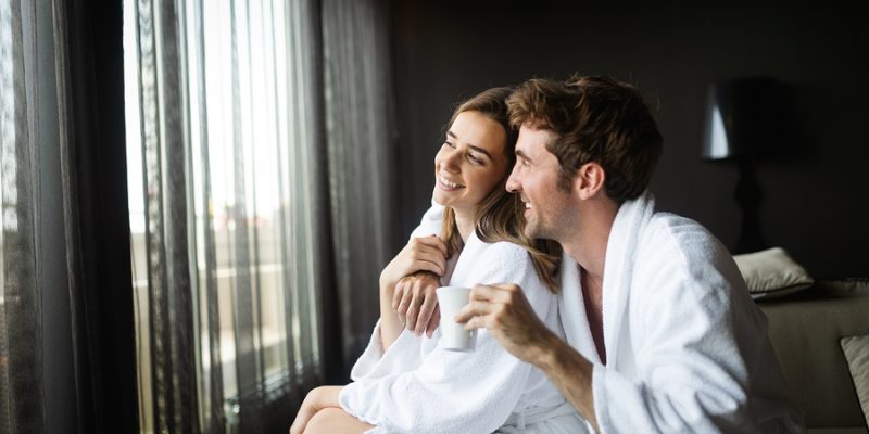 Couple wearing luxury spa robes enjoying wellness weekend and spa