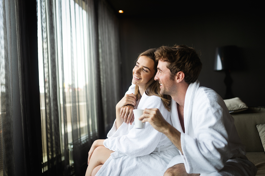 Couple wearing luxury spa robes enjoying wellness weekend and spa