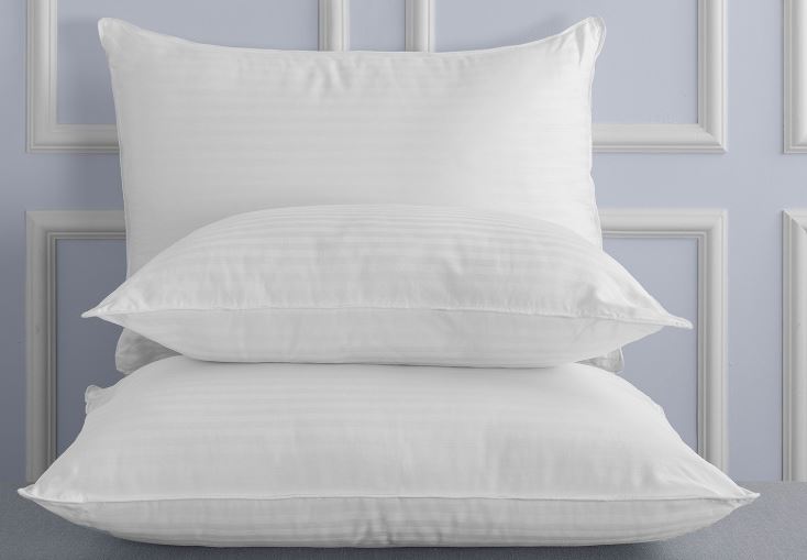Stack of three Dolce Notte II Pillows by Sobel Westex ona bed