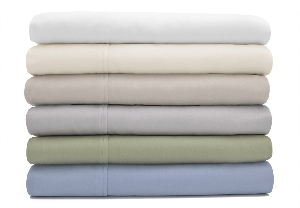 Six Dolce Notte sheet sets folded and stacked in a range of subtle colors