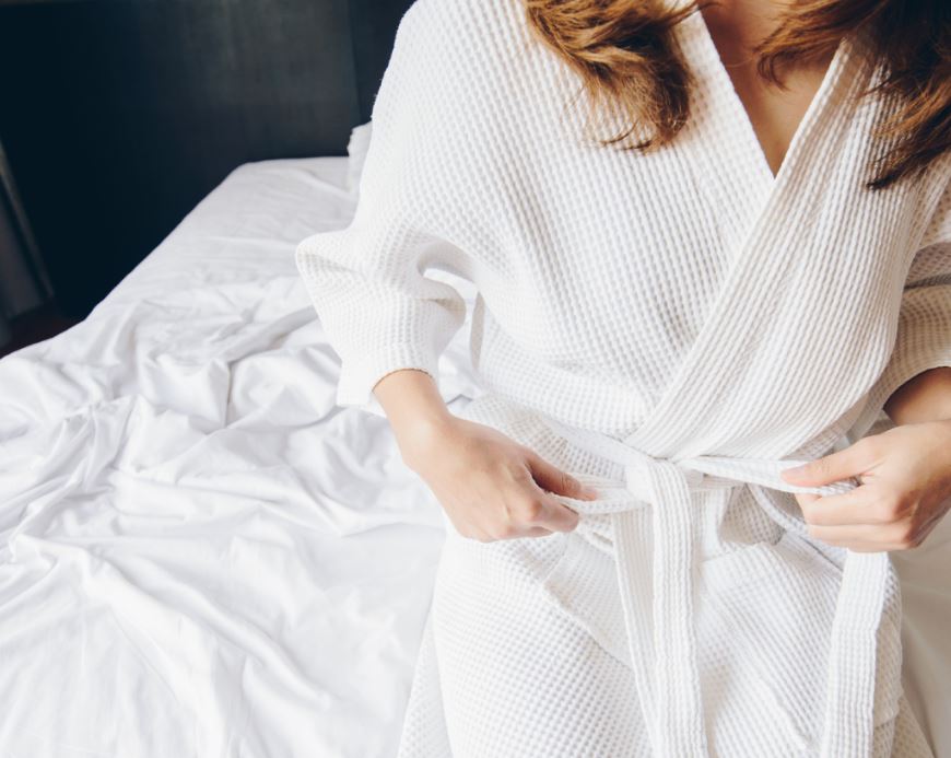 Woman with long hair wearing Diamond Kimono spa robe by Sobel Westex