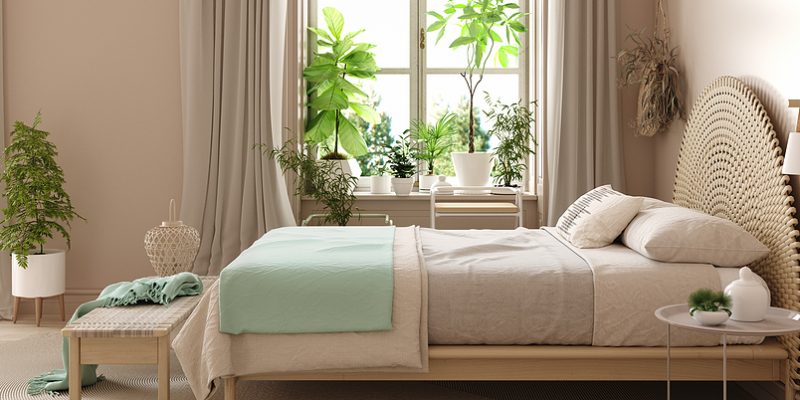 Bedroom interior with green plants and pastel colors mint green and beige bedding
