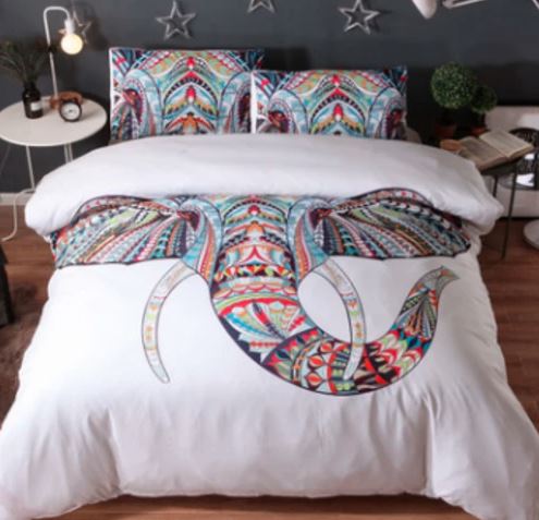 David Bromstadt White Elephant comforter set on bed colorful elephant wiht tusks on white background