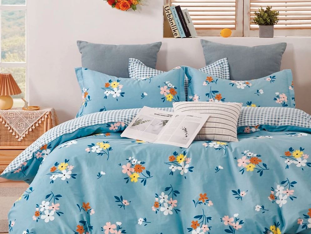 Sobel Westex Pure Elegance Blue Floral Comforter on cozy bed in a bright guest bedroom