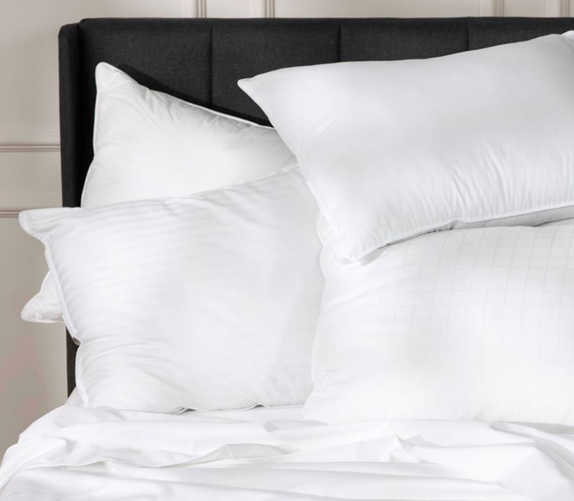 Four Sobel Westex luxury hotel pillows piled on a bed