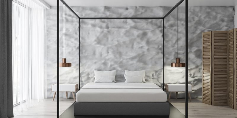 Interior of modern bedroom with white walls, concrete floor, white Egyptian cotton sheets, master bed and loft windows.