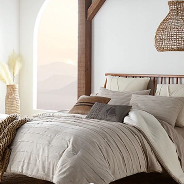 Sobel Westex Star Wars Jedi bedding collection bed set displayed on bed in desert home view of hills white stucco fireplace kimono style comforter, Star Wars designer pillows, chain link throw and sand sateen sheets