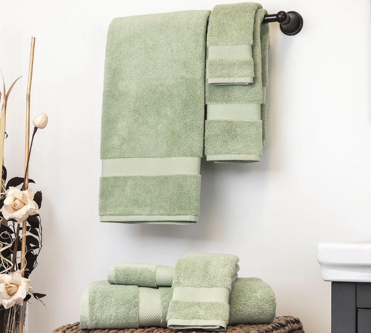Green Sobel luxury bath towels hanging on towel rack