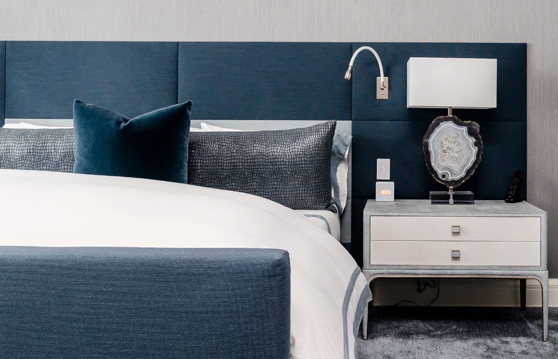 Hotel collection bedding in blues and grays, with complementary décor.