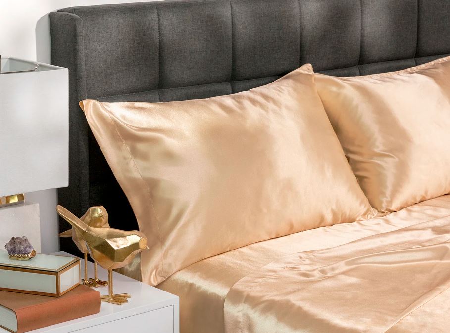 silky satin sheets and pillows in ivory