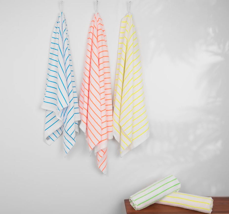 Hanging striped beach towels with beautiful vibrant colors