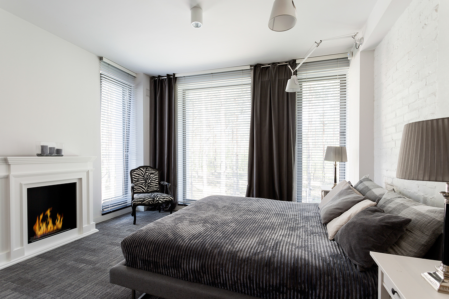 Bedroom with fall decor including cozy blankets and fireplace